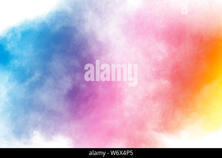 Abstract multi color powder explosion on white background.Freeze motion of dust particles splash. Stock Photo