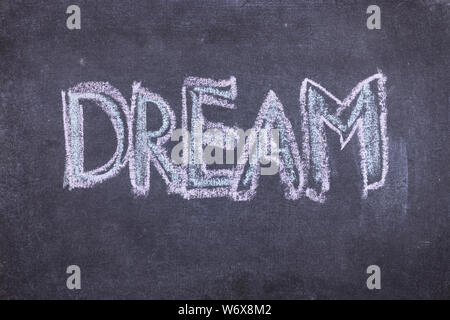 Dream. Chalk lettering on blackboard. Multi colored inscription on a chalkboard Stock Photo