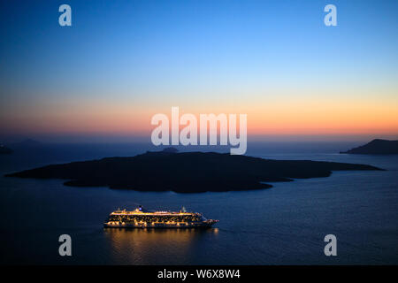 Photograph of the the sunset near the islands around Santorini in Greece