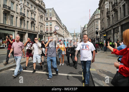 Tommy Robinson supporters in Oxford Street in London protesting against his prison sentence after he was jailed for nine months for contempt of court over a video he broadcast on Facebook which featured defendants in a criminal trial. Stock Photo