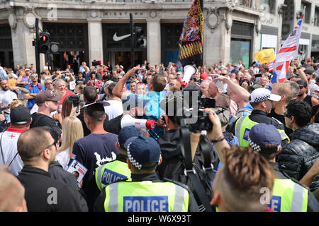 Tommy Robinson supporters in Oxford Street in London protesting against his prison sentence after he was jailed for nine months for contempt of court over a video he broadcast on Facebook which featured defendants in a criminal trial. Stock Photo