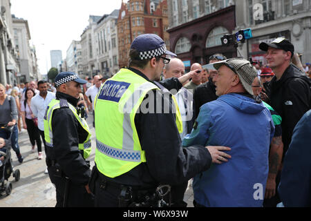 Tommy Robinson supporters in Oxford Street in London protesting against his prison sentence after he was jailed for nine months for contempt of court over a video he broadcast on Facebook which featured defendants in a criminal trial. Stock Photo