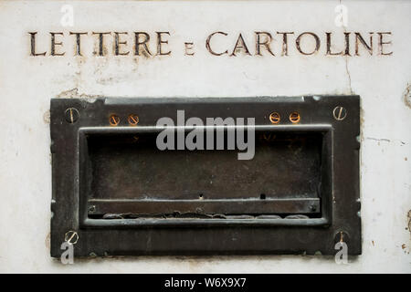old italian postbox on ancient marble wall of house in metal, symbol of vintage correspondence and mail Stock Photo