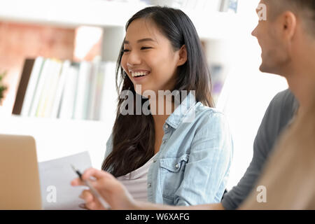 Diverse students or employees during meeting focus on asian female Stock Photo