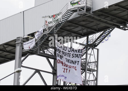 Mannheim, Germany. 3rd August 2019. A large banner flies from the occupied coal conveyor belt, reading '20 more years your profits instead of our future - Get out of coal energy now'. Activists from the Ende Gelande organisation have occupied the coal conveyor belt on the large coal power plant in Mannheim. They also block the main entrance of the plant, calling for an end to the use of coal in energy production and the use of renewable energy sources. Stock Photo