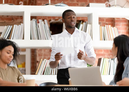 African man team leader makes a speech during business meeting Stock Photo