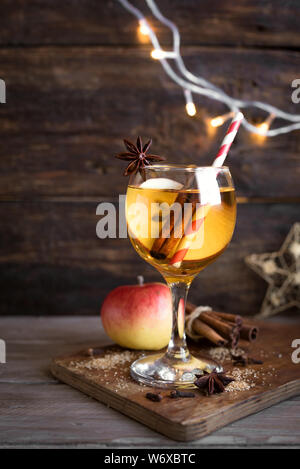 Hard apple cider (sangria, punch, fruit wine) for autumn and winter holidays - homemade festive Christmas, Thanksgiving drink on wooden table, copy sp Stock Photo