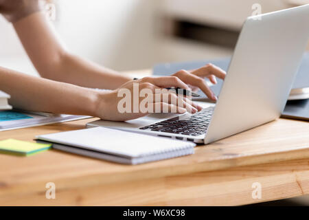 Closeup cropped image student girl hands typing using laptop Stock Photo