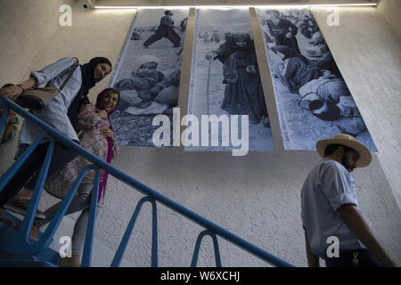 Tehran, Tehran, IRAN. 2nd Aug, 2019. People visit Iranian former AP photographer, Mohammad Sayad's exhibit at the Nabshi Gallery in Tehran, Iran. Credit: Rouzbeh Fouladi/ZUMA Wire/Alamy Live News Stock Photo