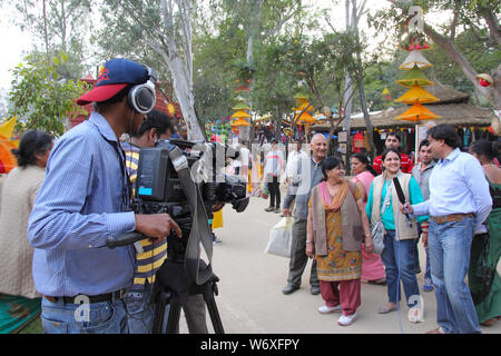 TV reporter taking interview of tourists at Surajkund Crafts Mela, Surajkund, Faridabad, Haryana, India Stock Photo