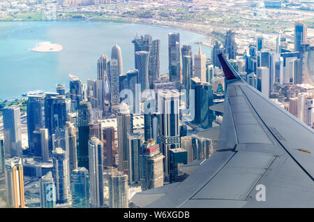 View from the plane to the Doha cityscape. Business district of the city. Flight to Doha, Qatar. Stock Photo