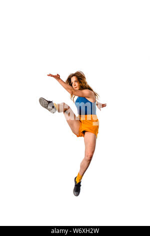An urban woman is doing breakdance in the studio while jump in the air Stock Photo