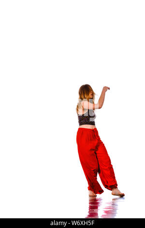 Aerobics woman. Portrait of pretty smiling girl training dance on studio background Stock Photo