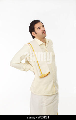 Indian man suffering from Back Pain or injury isolated over white ...