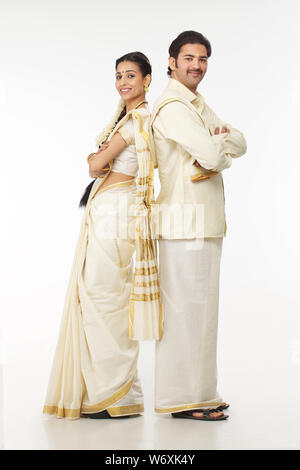 South Indian couple standing back to back Stock Photo - Alamy