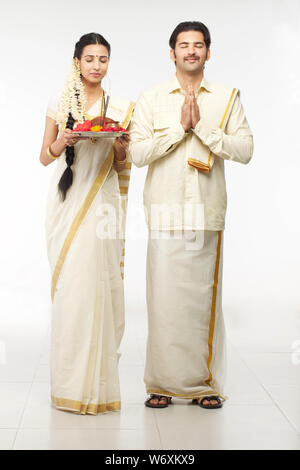 South Indian couple praying and smiling Stock Photo - Alamy