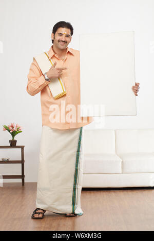 south indian man showing a blank placard