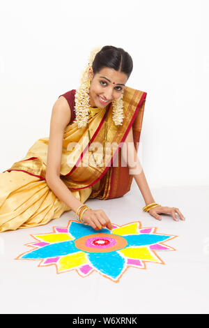 South Indian woman making a rangoli Stock Photo