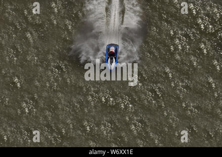 WAVERUNNER From a height measuring more than 400 feet up  on the George Washington Bridge a man on a jet ski is seen riding waves in the Hudson river. Stock Photo