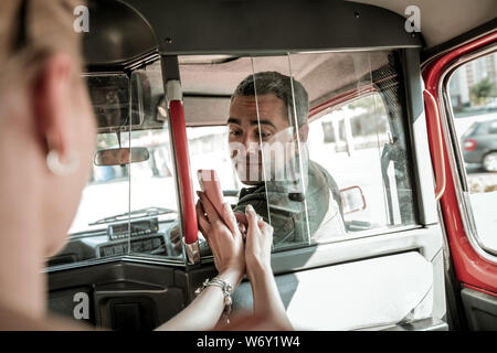 Woman showing a map to the car driver. Stock Photo
