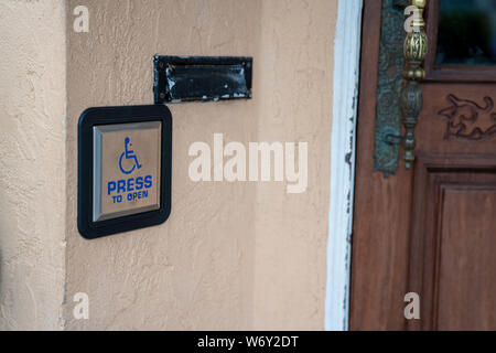 Press to open handicap button disability accessibility outside of door entrance Stock Photo