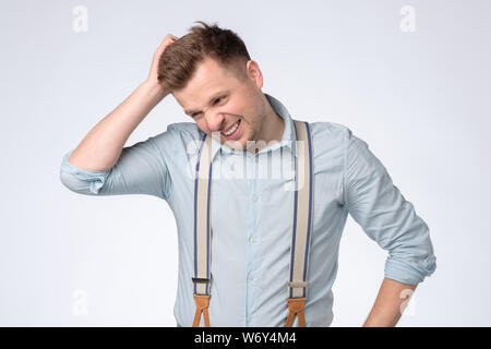 Funny young man hold his head in hand forgotten something Stock Photo