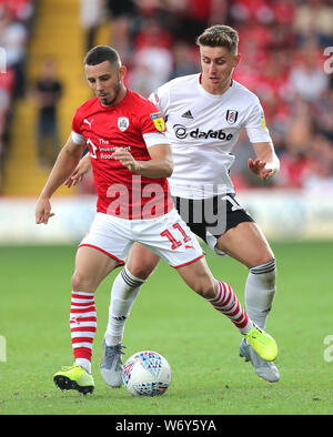 Fulham's Tom Cairney (right) and Barnsley's Conor Chaplin (left) battle for the ball during the Sky Bet Championship match at Oakwell Barnsley. Stock Photo