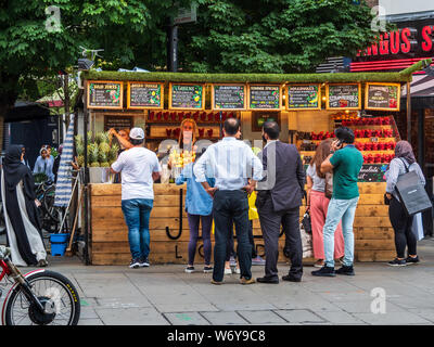 Fresh Fruit and Juice stand on Oxford Street in Central London Stock Photo