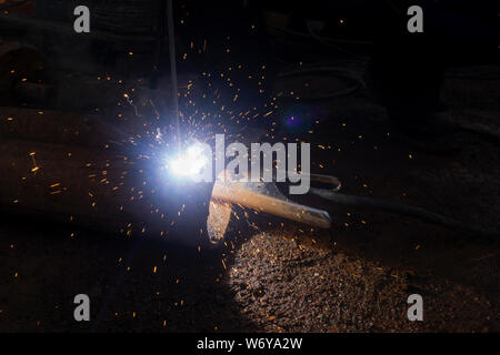 Operator welding steel construction. Industrial worker during welding works Stock Photo