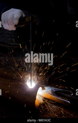 Operator welding steel construction. Industrial worker during welding works Stock Photo