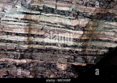 Soil cut-sandstone, stones, clay, sand structure and layers. slice of sand with layers of different structures. Stock Photo