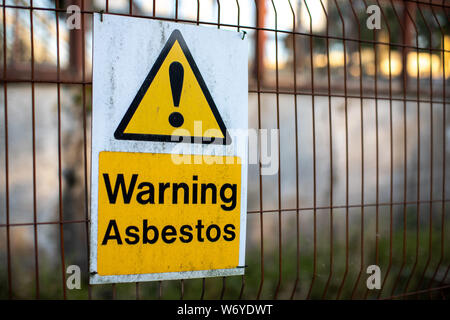 Asbestos warning signs for health and safety on a construction site Stock Photo