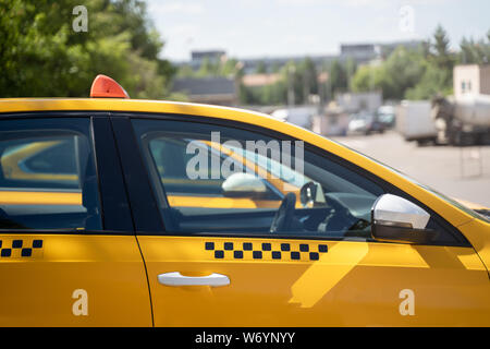 Photo of yellow taxi on street in summer Stock Photo
