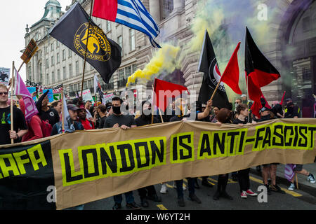 London, UK. 3rd August 2019. Anti-Fascists with the 'London is Anti-Fascist' banner at the front of the march in London to stop the racist 'Free Tommy' protesters marching. They say Tommy Robinson, in prison for deliberate contempt of court, is part of a far-right movement spreading violence across the world, whipping up hatred against Muslims and refugees. The Anti-fascists set off up Regent St and the Anti-racists joined behind them. Police stopped them close to Oxford Circus, but they went through side streets to get close to the 'Free Tommy' event before being stopped again. Peter Marshall Stock Photo