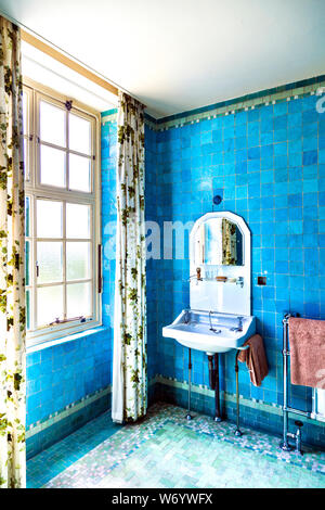 Interior of a bathroom with blue tiles at Eltham Palace, UK Stock Photo