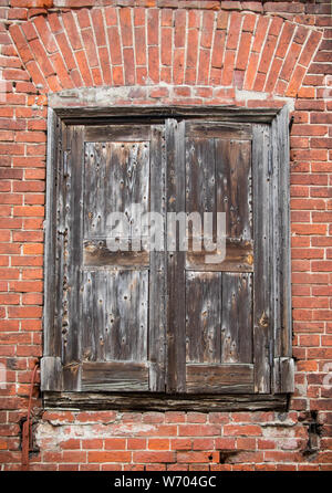 Old closed wooden window with shutters Stock Photo