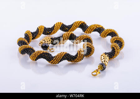 Handmade small bead bracelet in black and gold beads Stock Photo