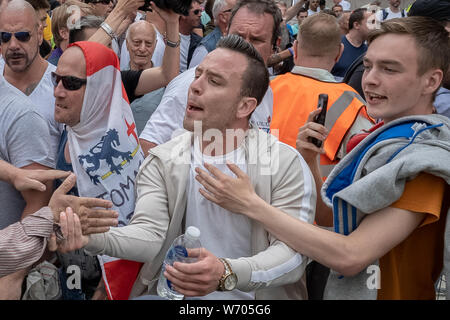Danny Tommo (pictured) – real name Daniel Thomas, leads the 'Free Tommy Robinson' protest. Police arrest twenty four during a mass demonstration in support of the jailed Tommy Robinson, real name Stephen Yaxley-Lennon, who was sentenced last month to nine months in prison after being found guilty in contempt of court. Counter-protesters including antifascist activists and the anti-racist group: Stand Up to Racism, opposed the pro-Robinson demonstrators with protest groups kept apart by met police with some clashes. London, UK. Stock Photo