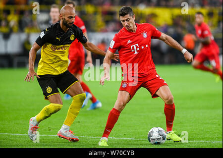Omer Toprak from Borussia Dortmund (L) and Robert Lewandowski from Bayern Munich (R) are seen in action during the Germany Supercup Final 2019 match between Borussia Dortmund and Bayern Munich.(Final score: Borussia Dortmund 2:0 Bayern Munich) Stock Photo