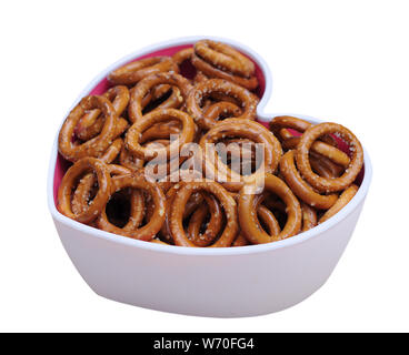 pretzel rings in heart shape bowl isolated on white Stock Photo