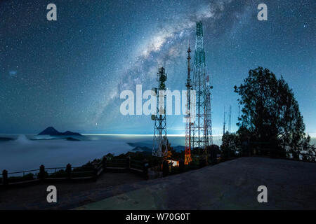 Mount Bromo covered with mist and milky way galaxy stars shining in the sky at night, Java Indonesia Stock Photo