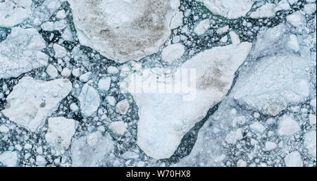 Icebergs drone aerial image top view - Climate Change and Global Warming. Icebergs from melting glacier in icefjord in Ilulissat, Greenland. Arctic nature ice landscape in Unesco World Heritage Site. Stock Photo