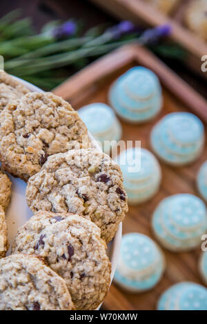 gourmet dessert trays with gluten-free chocolate chip cookies and small wedding cake cookie on serving tray and platter Stock Photo