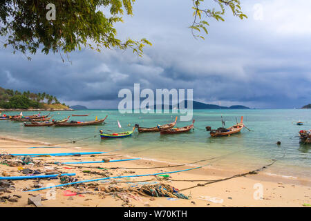 Fishing boats moored in a bay with an approaching storm, Rawai, Phuket, Thailand Stock Photo