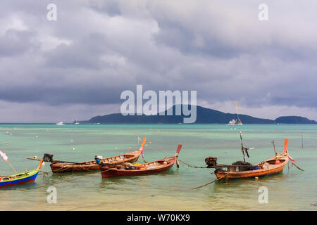 Fishing boats moored in a bay with an approaching storm, Rawai, Phuket, Thailand Stock Photo