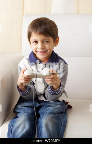 Boy playing video game at home Stock Photo