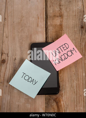Handwriting text United Kingdom. Conceptual photo Island country located off the northwestern coast of Europe Smartphone two colored sticky notes lyin Stock Photo