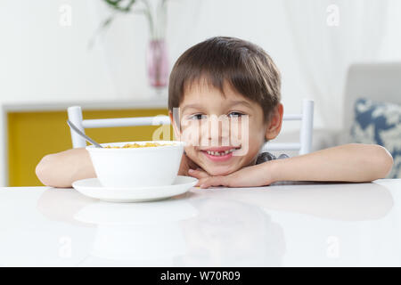 Boy having breakfast and smiling Stock Photo