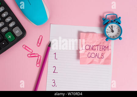 Conceptual hand writing showing Longterm Goals. Concept meaning Strategic target that is required more time for completion Calculator clock mouse crus Stock Photo
