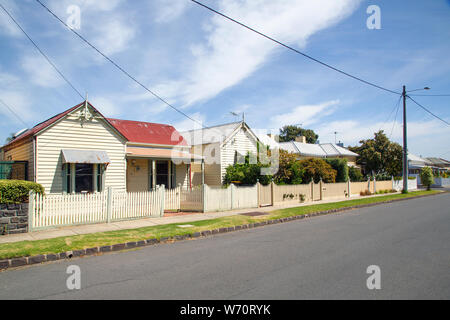 Williamstown, Australia: March, 2019: Rundown traditionally built bungalow cottages in the Australian style with verandah and picket fence. Stock Photo